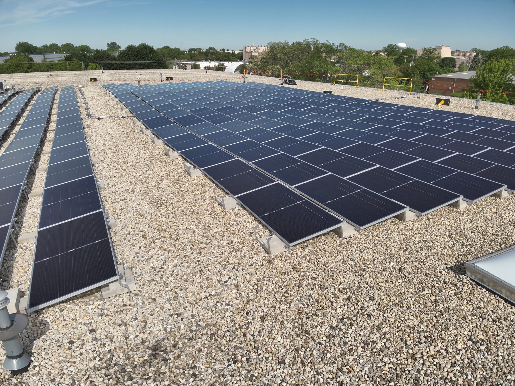 Ballasted solar racking sitting on a commercial flat roof membrane without penetrations